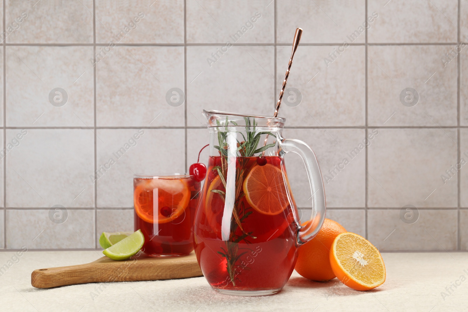 Photo of Delicious punch and ingredients on light table