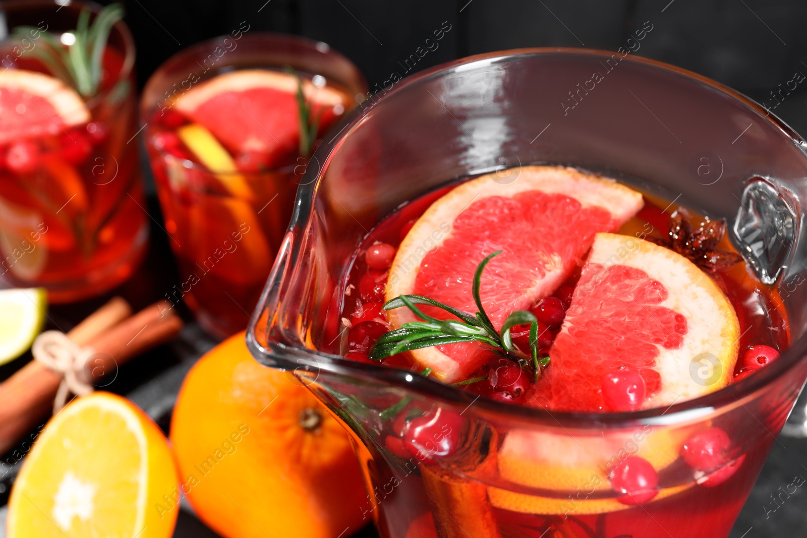 Photo of Delicious punch with rosemary in jug, closeup