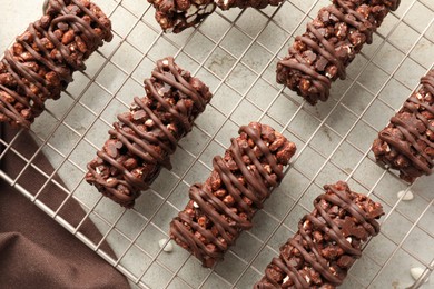 Delicious chocolate puffed rice bars on gray textured table, top view