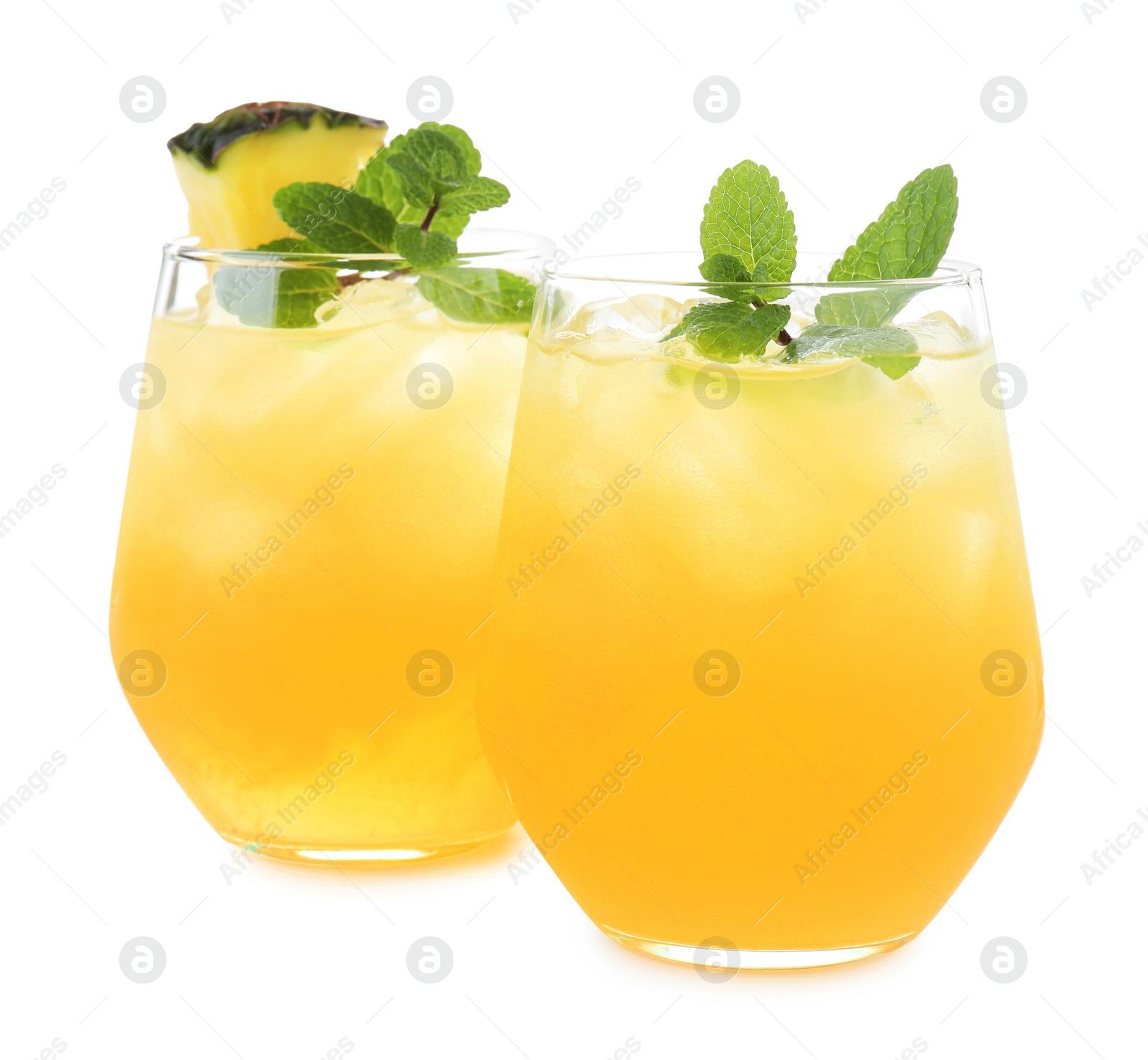 Photo of Tasty pineapple cocktail with mint in glasses isolated on white