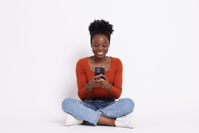 Photo of Happy woman with smartphone on white background