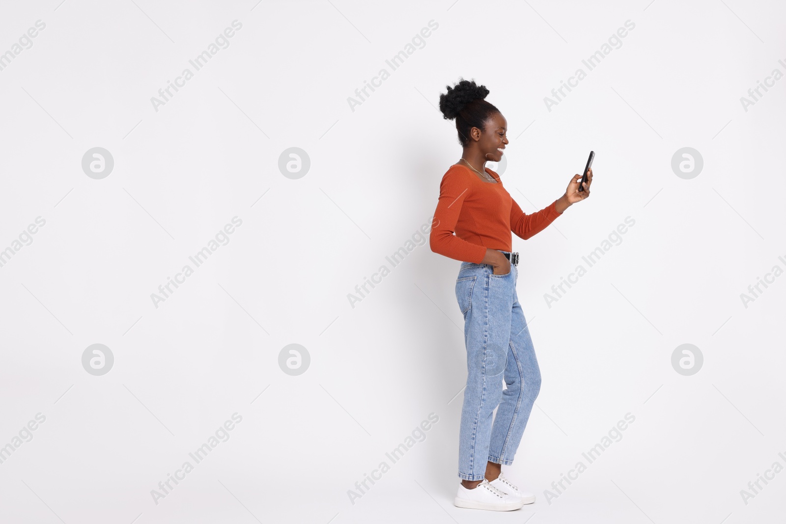 Photo of Happy woman with smartphone on white background. Space for text