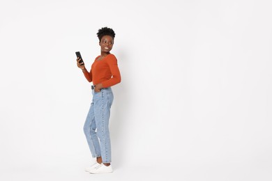 Photo of Happy woman with smartphone on white background. Space for text