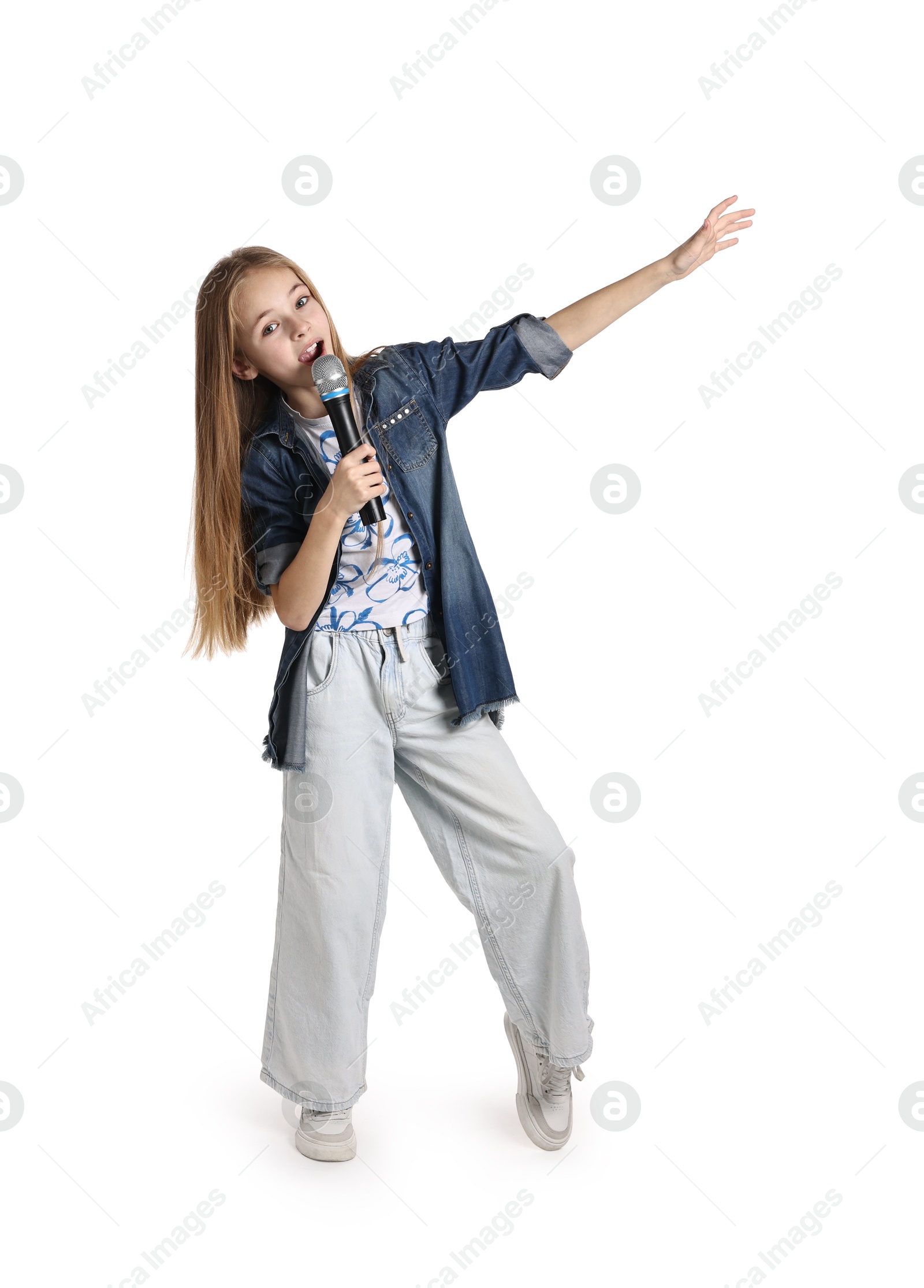 Photo of Little girl with microphone singing on white background