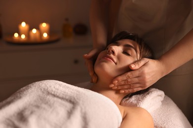 Photo of Young woman receiving massage in spa salon