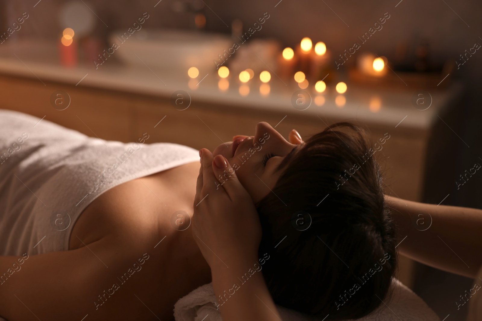 Photo of Young woman receiving massage in spa salon