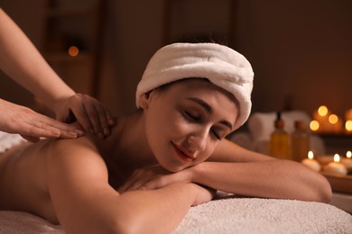 Photo of Young woman receiving massage in spa salon