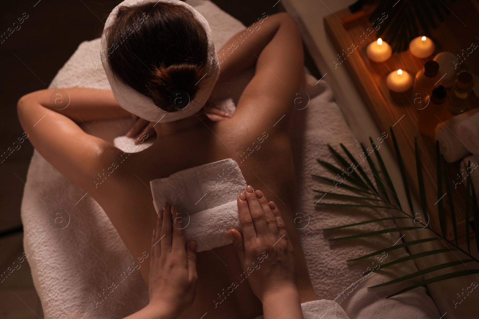 Photo of Woman receiving back massage in spa salon, top view