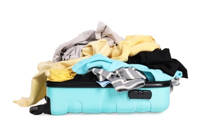 Photo of Open suitcase full of different messy clothes isolated on white