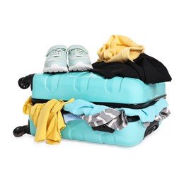 Photo of Suitcase full of different messy clothes and sneakers isolated on white