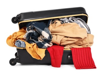 Photo of Packed suitcase full of clothes isolated on white