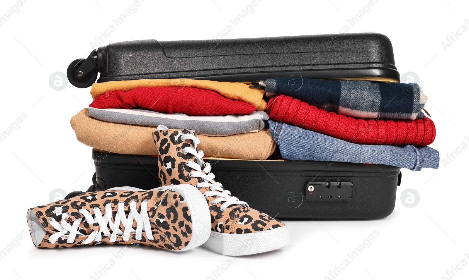 Photo of Packed suitcase full of clothes isolated on white