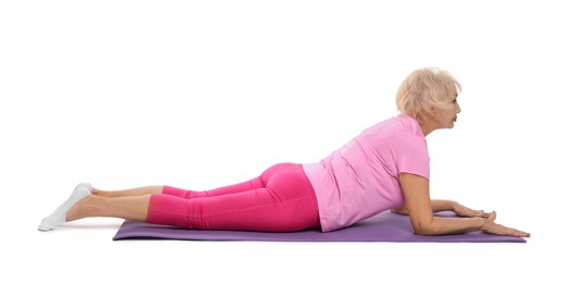 Photo of Senior woman exercising with fitness mat on white background