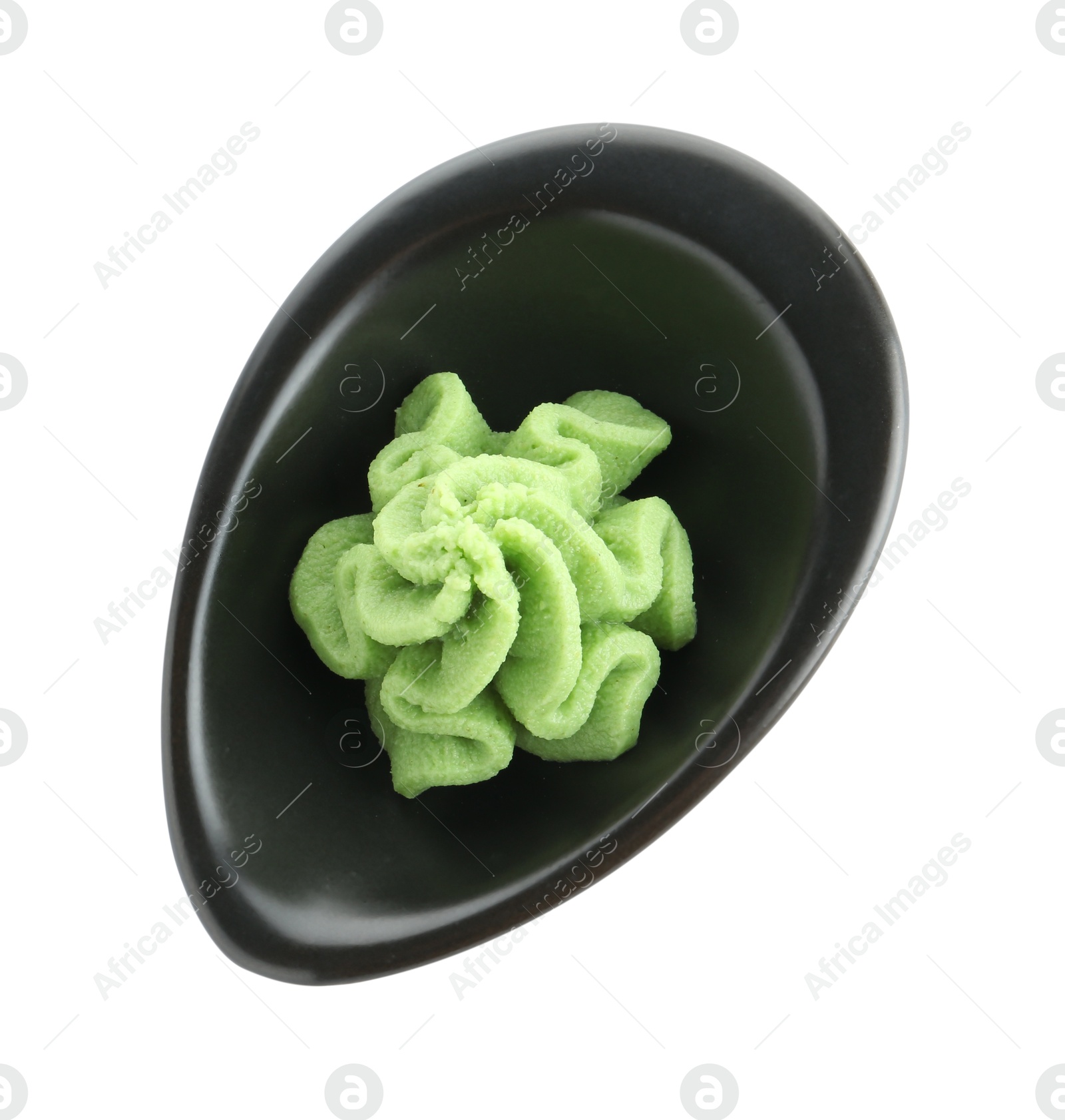 Photo of Hot wasabi paste in gravy boat isolated on white, top view