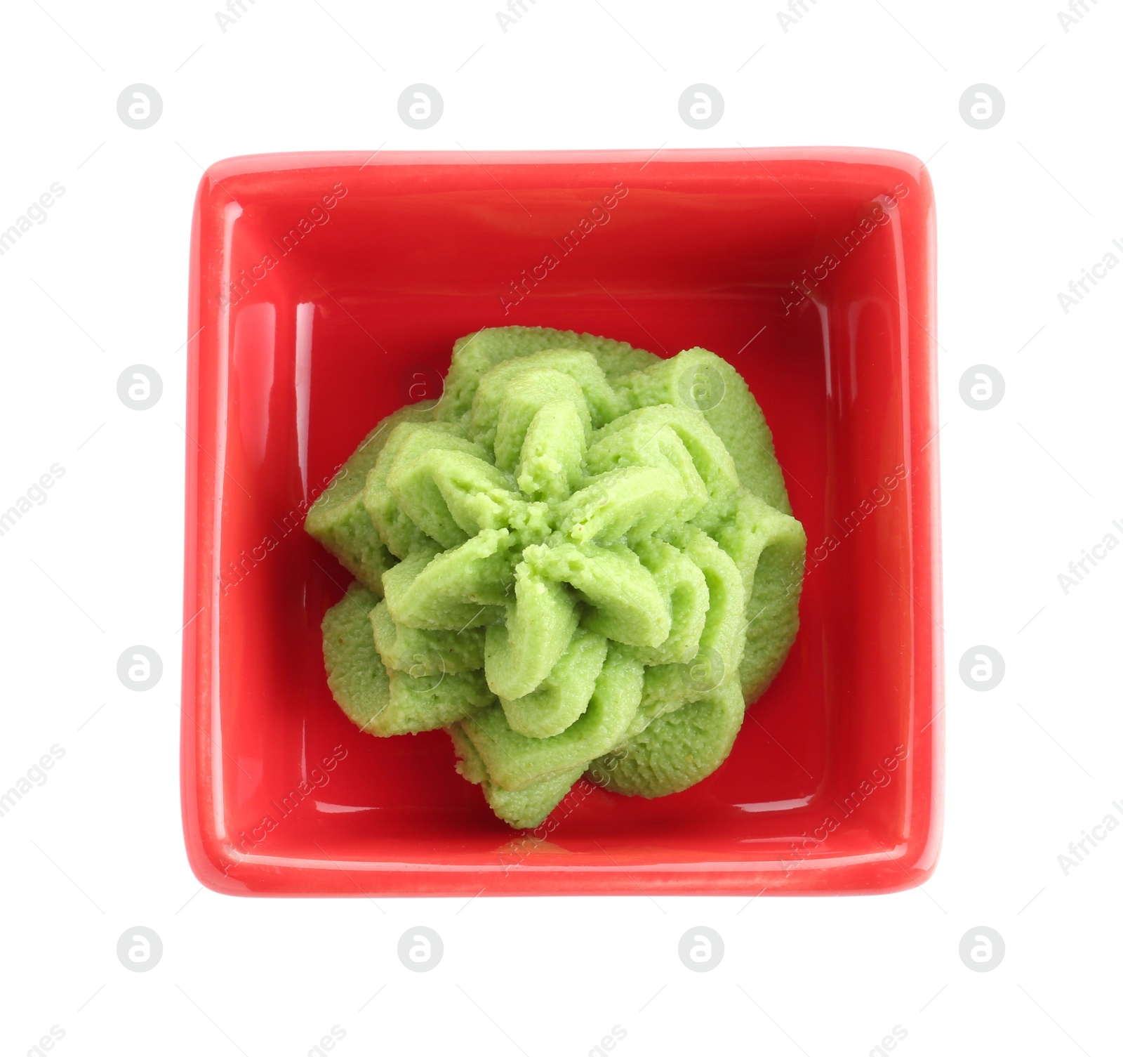 Photo of Hot wasabi paste in bowl isolated on white, top view