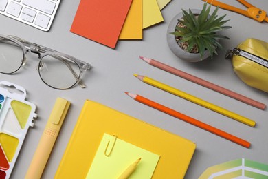 Photo of Designer's workplace. Flat lay composition with stationery and keyboard on light grey background