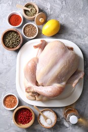 Fresh raw turkey and different products on gray textured table, flat lay