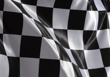 Photo of Racing checkered flag as background, closeup view