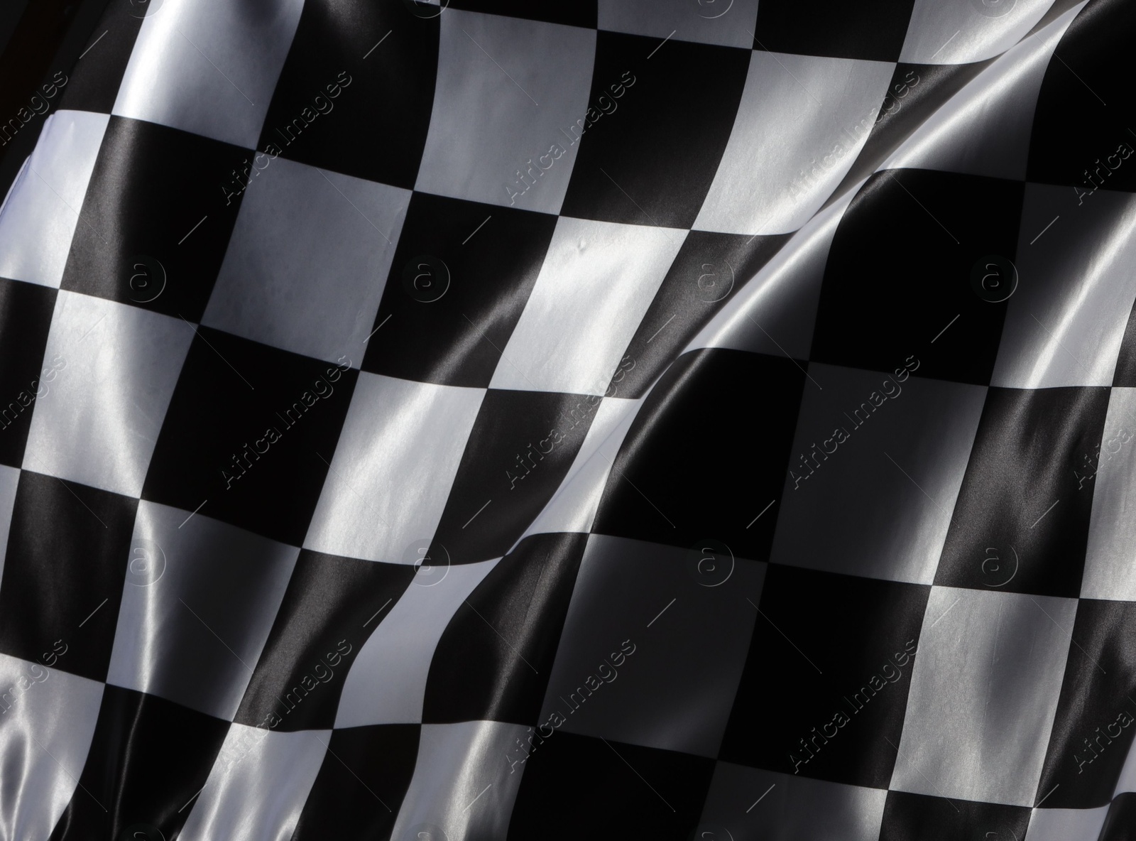 Photo of Racing checkered flag as background, closeup view