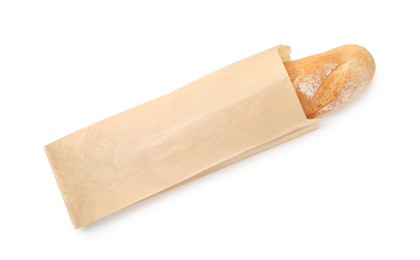 Photo of Freshly baked baguette in paper bag isolated on white, top view