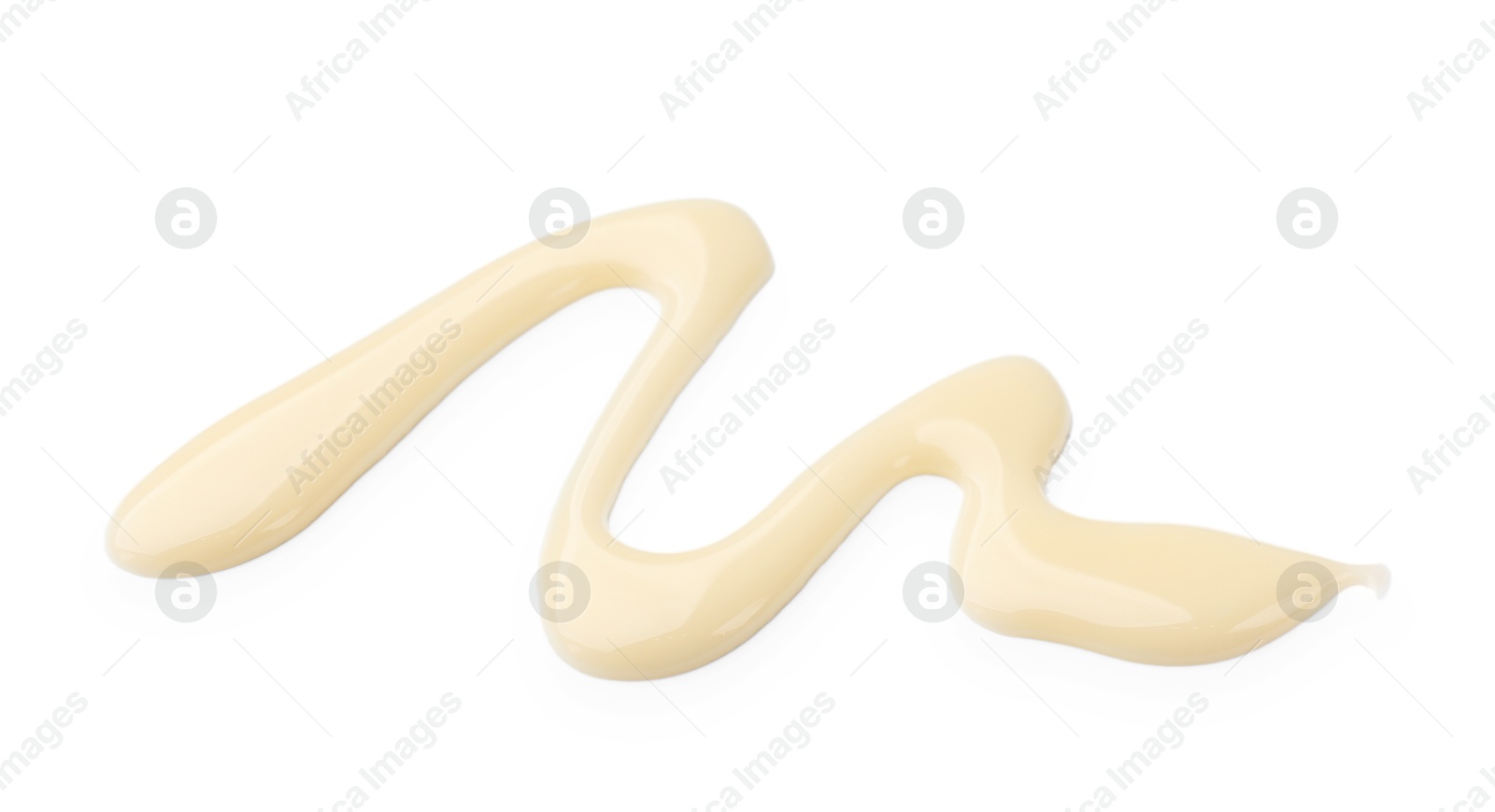 Photo of Spilled tasty condensed milk isolated on white