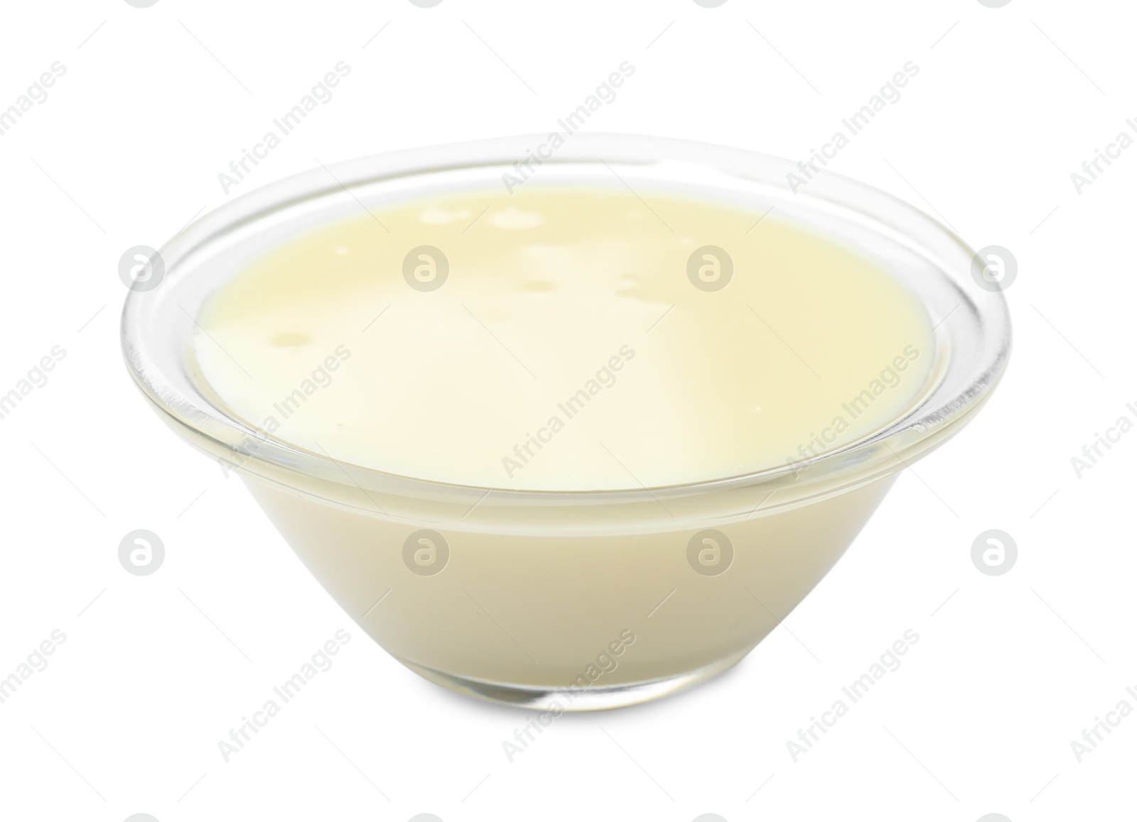 Photo of Condensed milk in bowl isolated on white