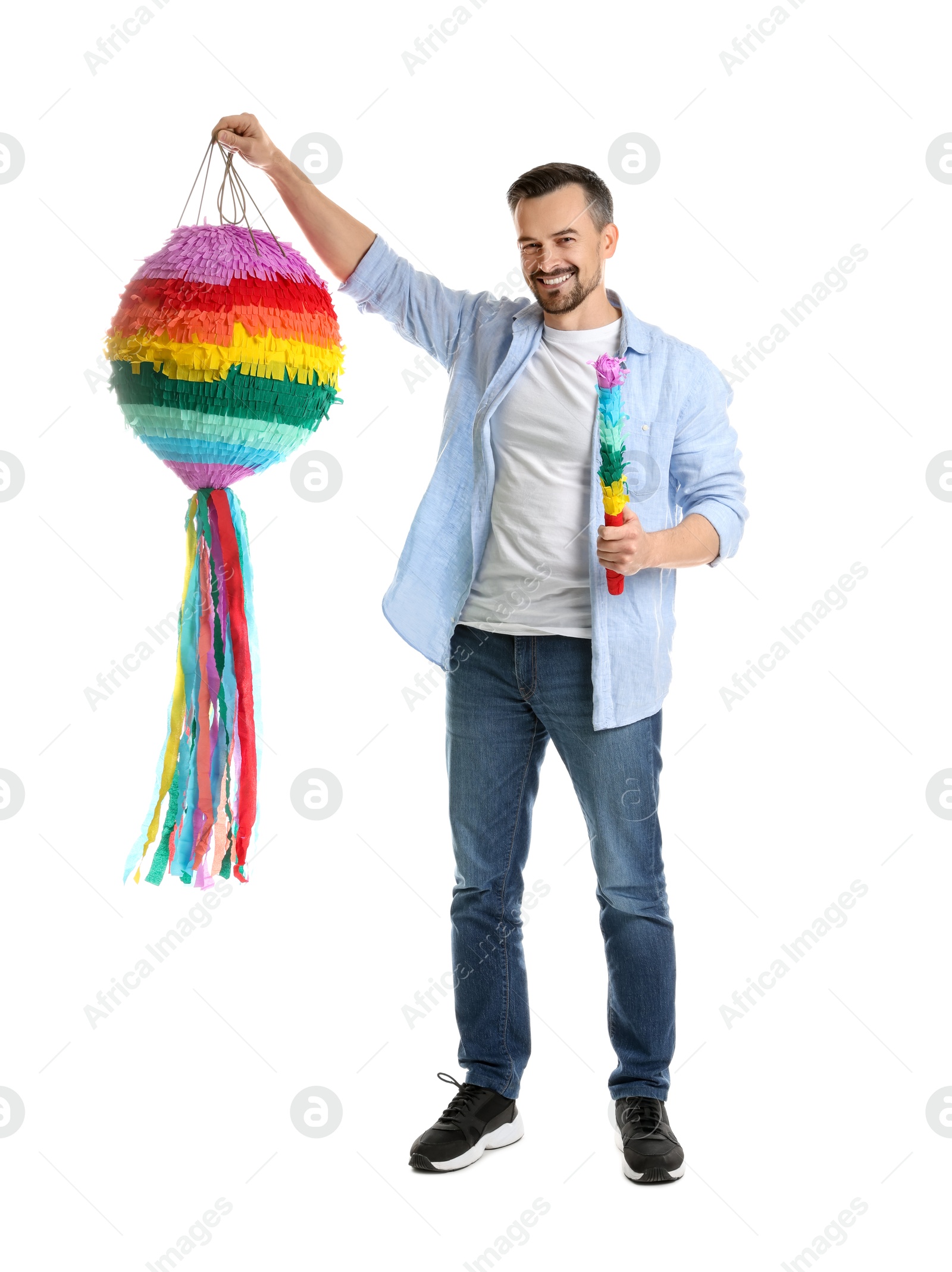 Photo of Happy man with colorful pinata and stick on white background