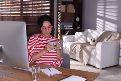 Photo of Beautiful woman working on computer at desk in home office