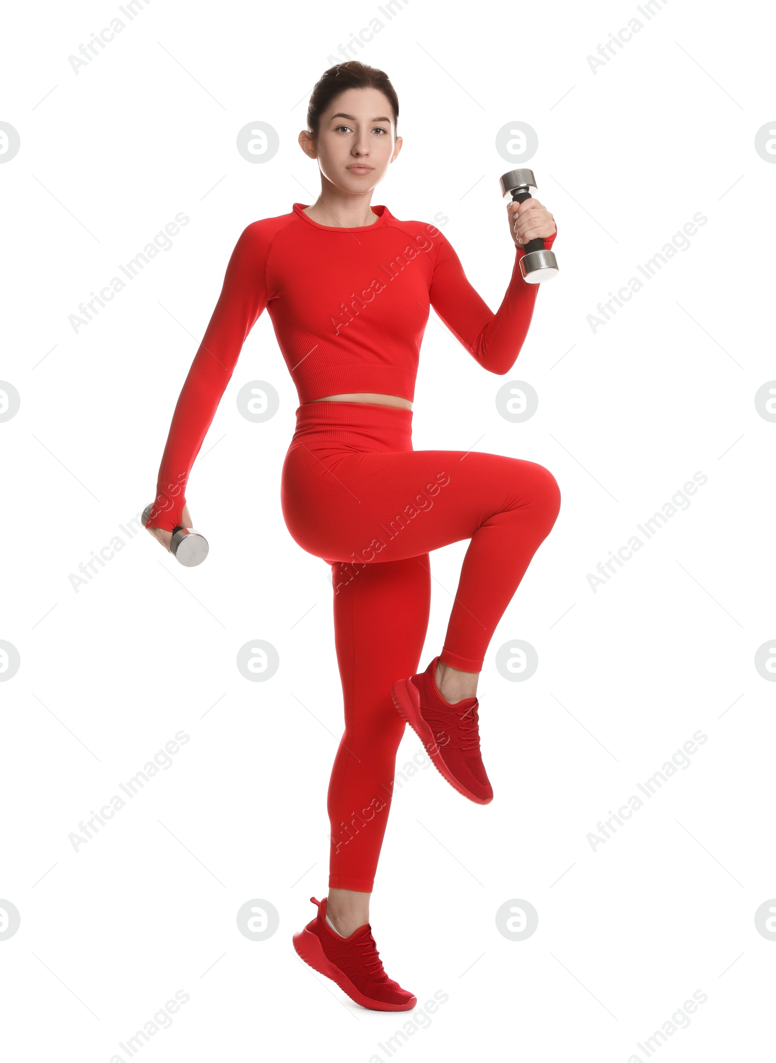 Photo of Woman in sportswear exercising with dumbbells on white background