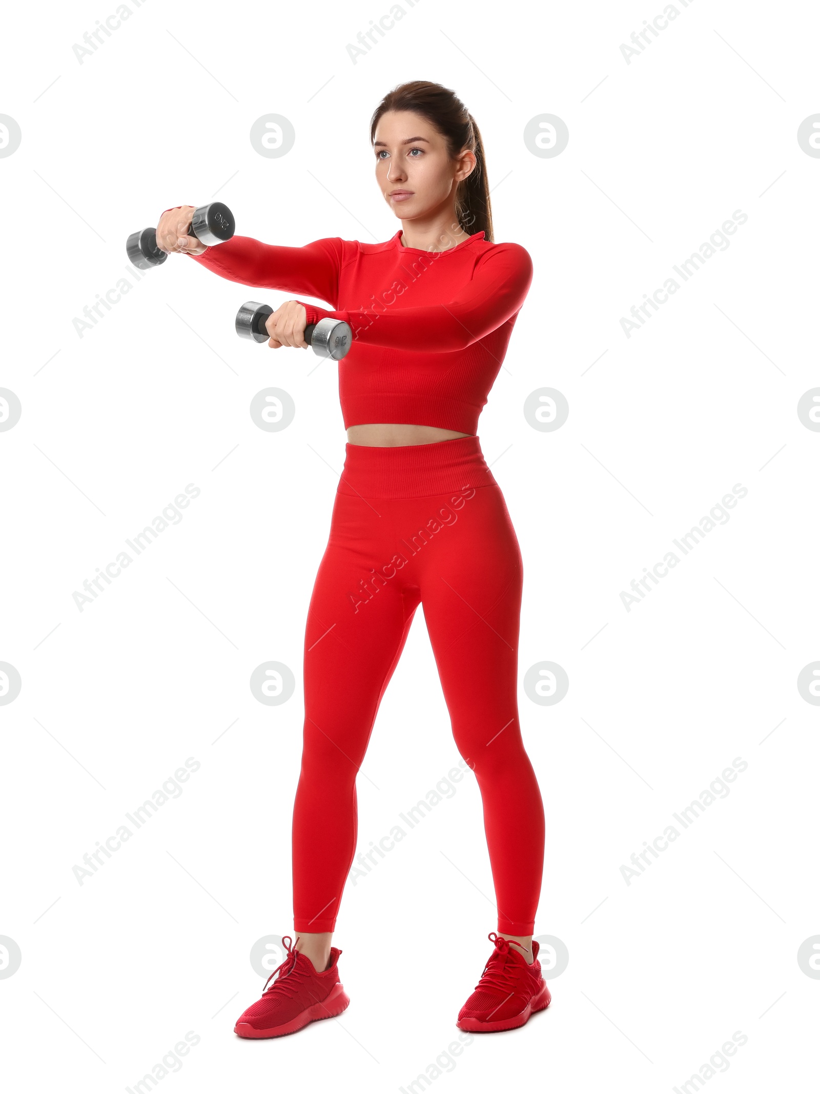 Photo of Woman in sportswear exercising with dumbbells on white background