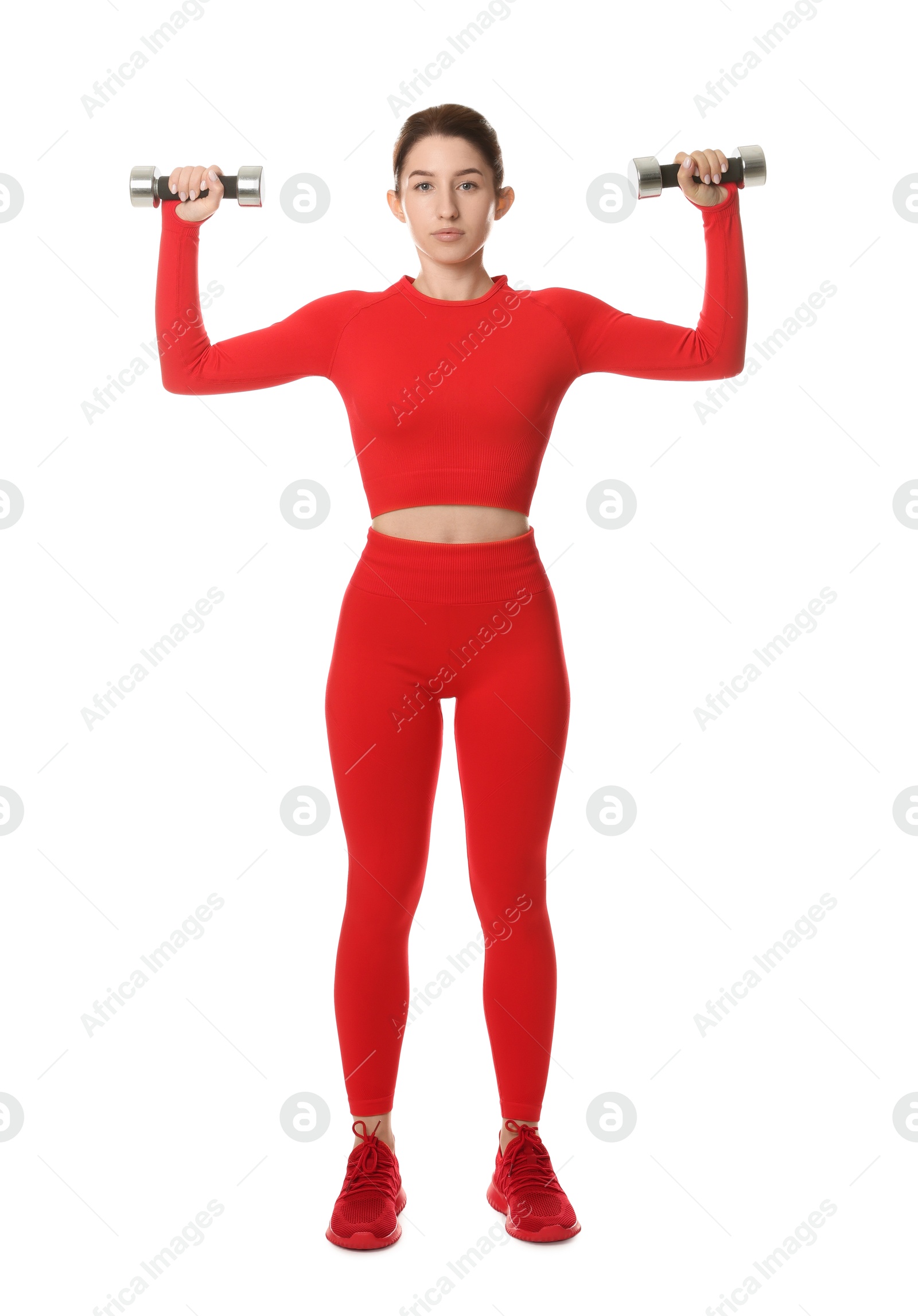 Photo of Woman in sportswear exercising with dumbbells on white background