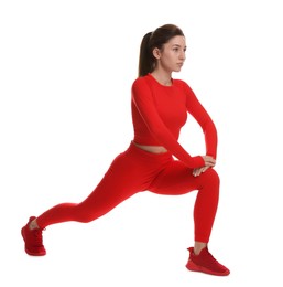 Photo of Woman in sportswear exercising on white background