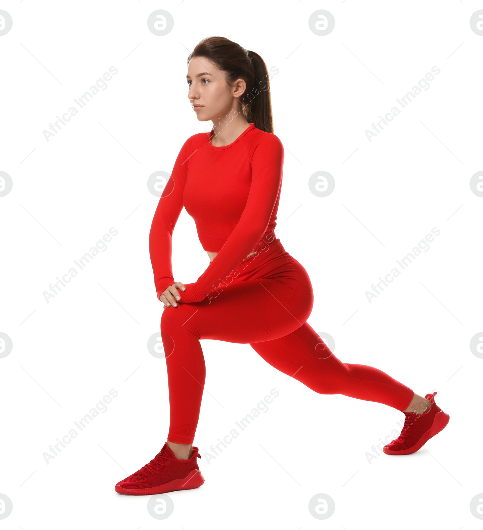 Photo of Woman in sportswear exercising on white background