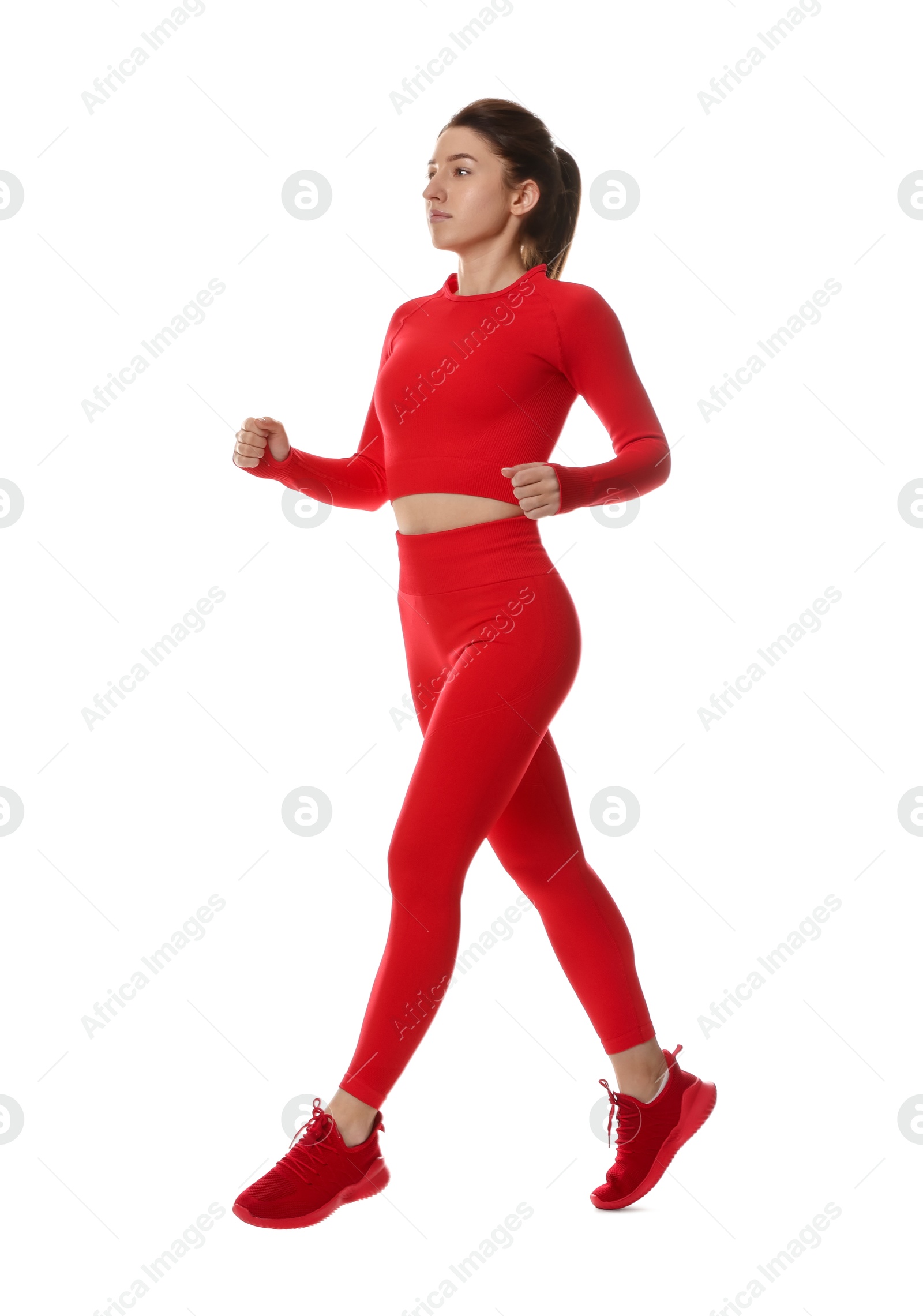 Photo of Woman in sportswear exercising on white background