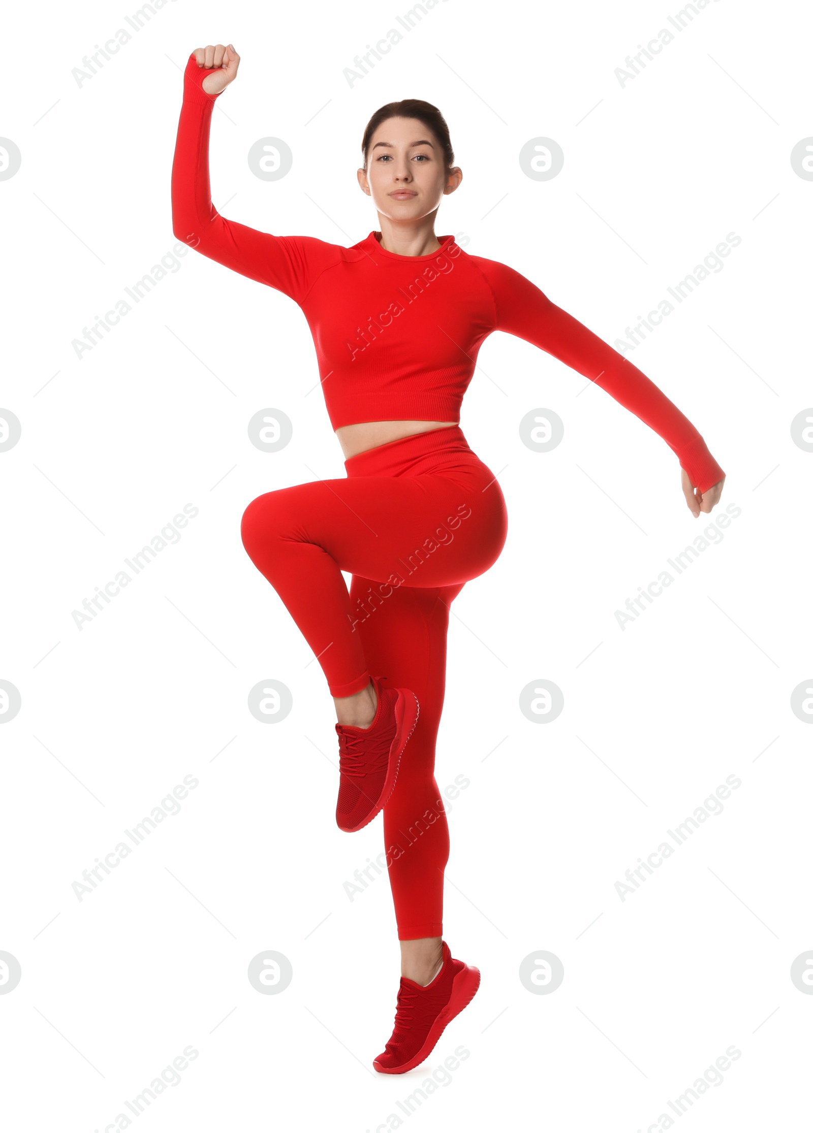 Photo of Woman in sportswear exercising on white background