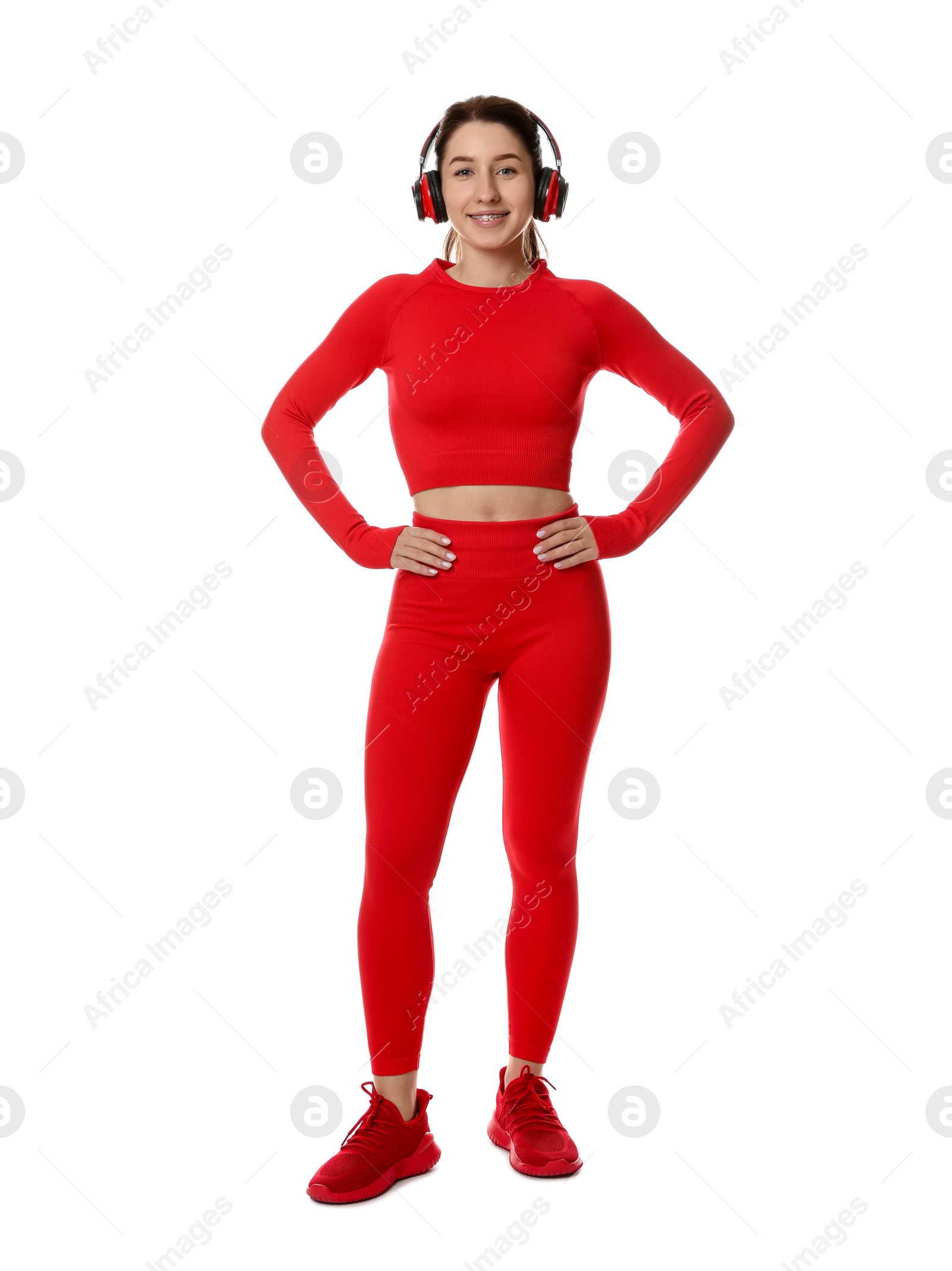 Photo of Woman in sportswear and headphones on white background