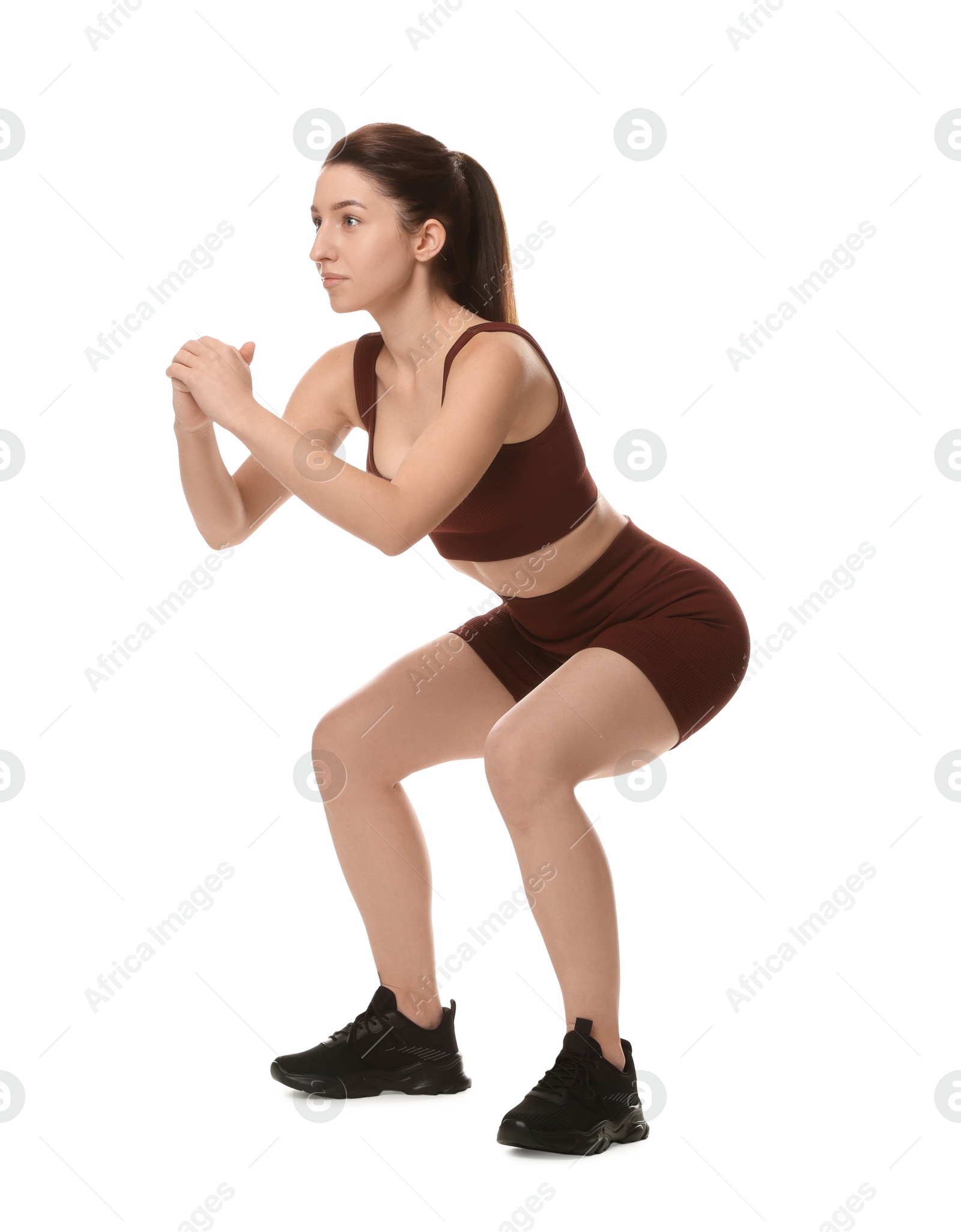 Photo of Woman in sportswear exercising on white background