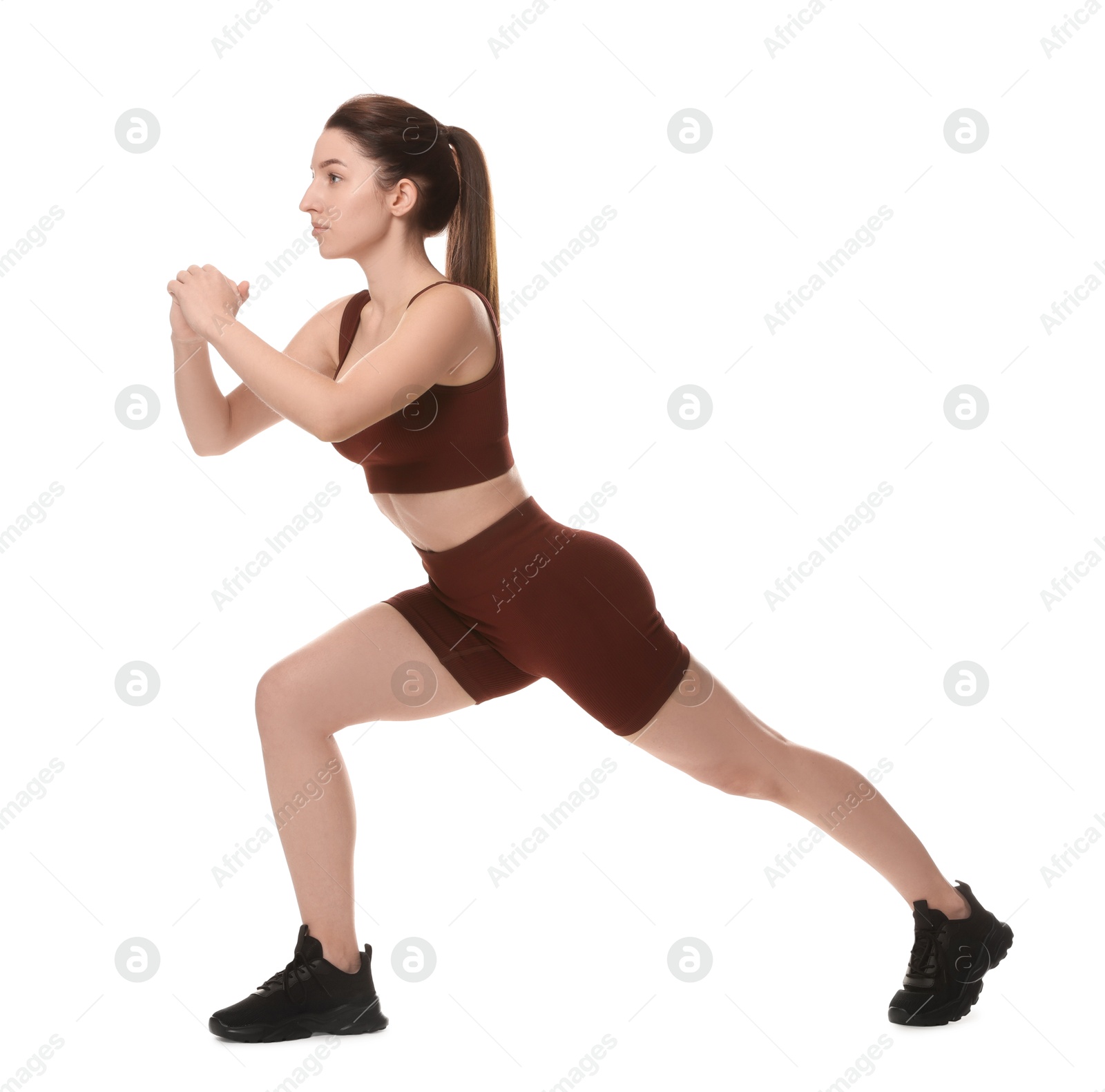 Photo of Woman in sportswear exercising on white background