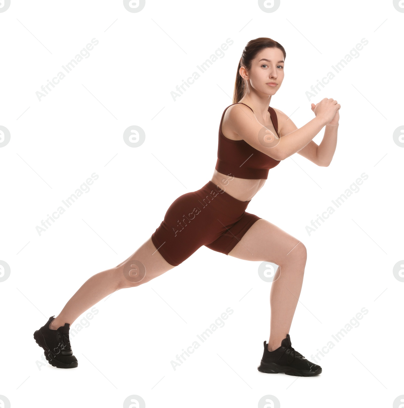 Photo of Woman in sportswear exercising on white background