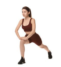 Photo of Woman in sportswear exercising on white background