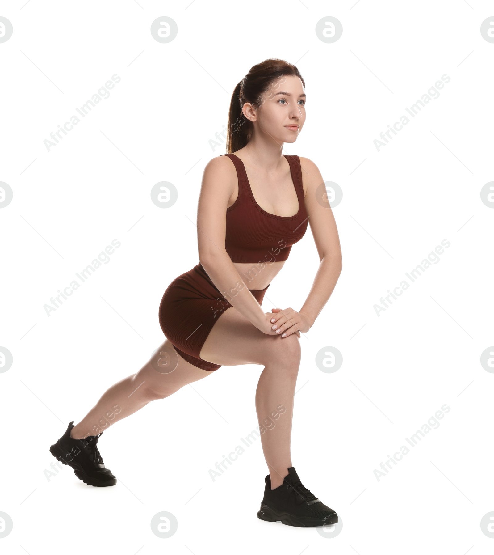 Photo of Woman in sportswear exercising on white background