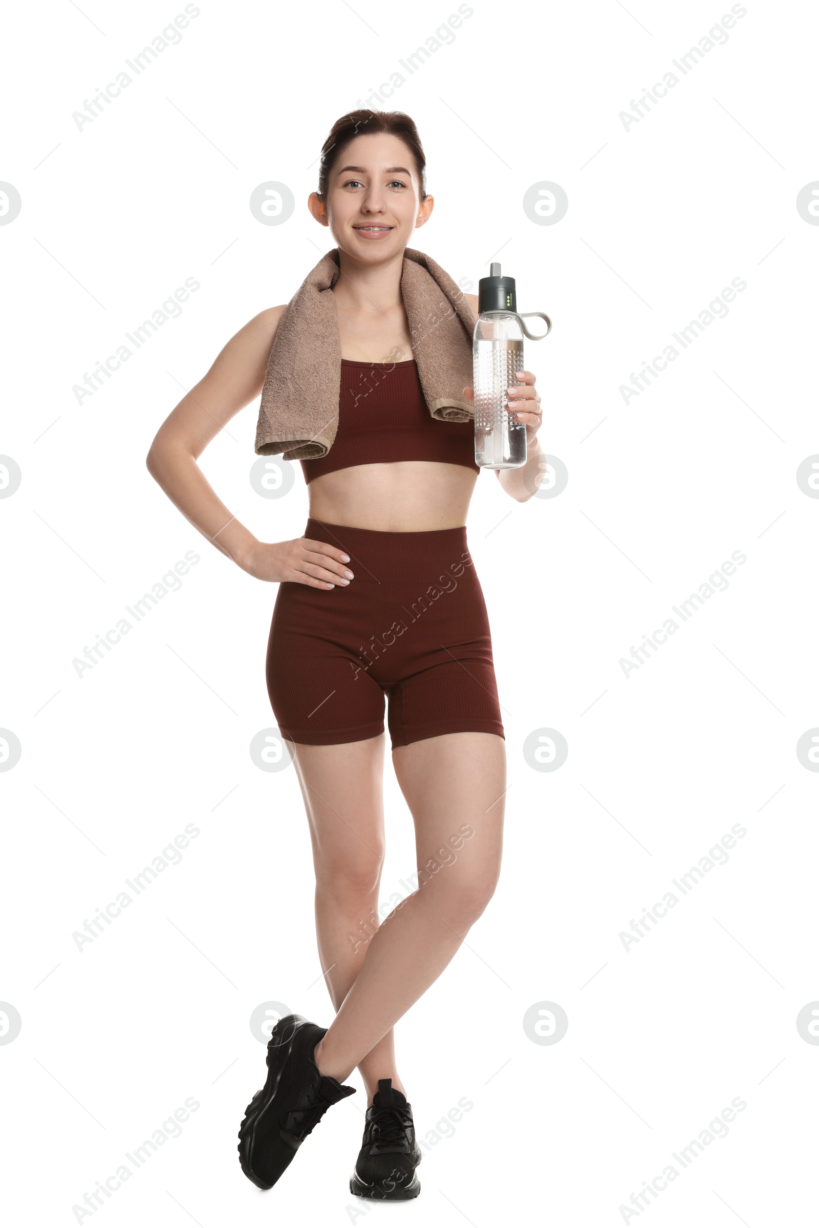 Photo of Woman in sportswear with bottle of water on white background