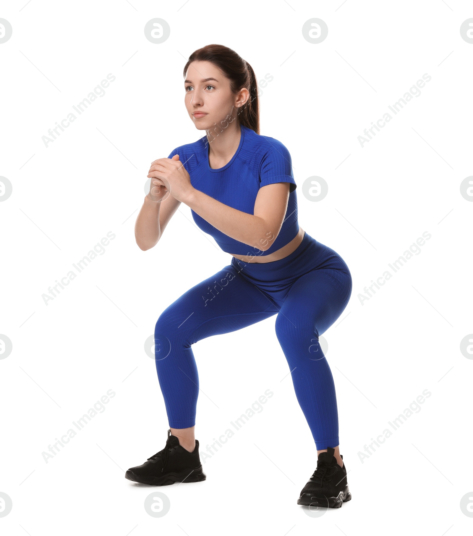 Photo of Woman in sportswear exercising on white background