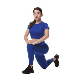 Photo of Woman in sportswear exercising on white background