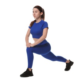 Photo of Woman in sportswear exercising on white background