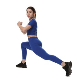 Photo of Woman in sportswear exercising on white background