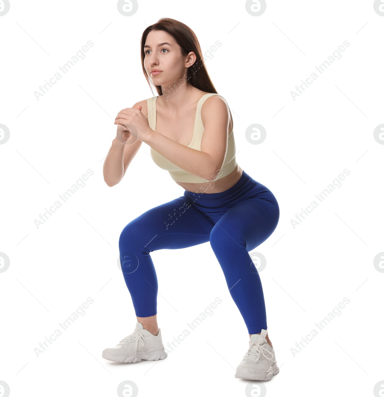 Photo of Woman in sportswear exercising on white background