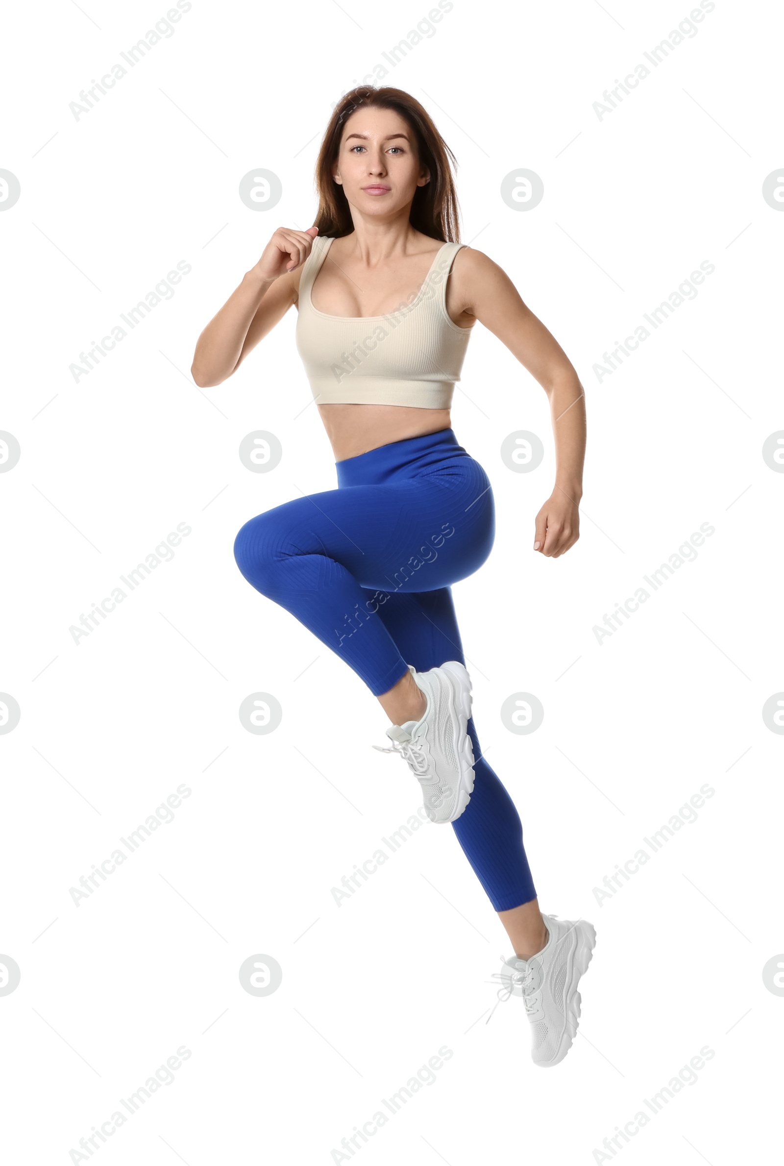 Photo of Woman in sportswear exercising on white background