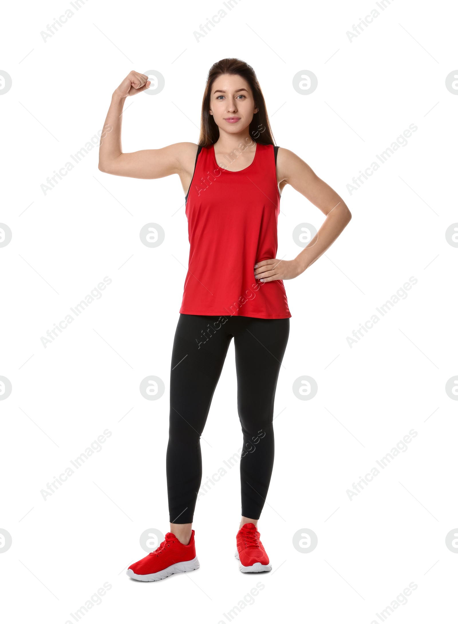 Photo of Woman in sportswear showing her bicep on white background