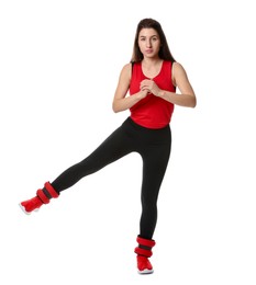 Photo of Woman in sportswear exercising with ankle weights on white background